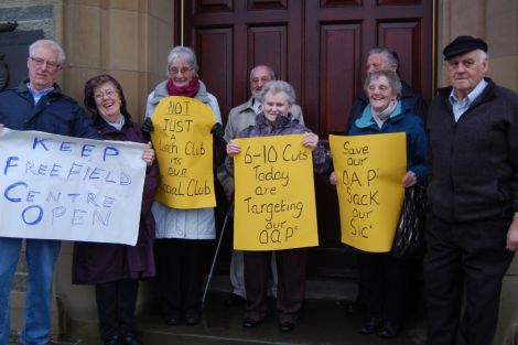 A small group of protesters outside the council chamber hoping to save Lerwick's Freefield Centre. They succeeded in having it moved into the ,long list of items under review. Pic. Shetland News