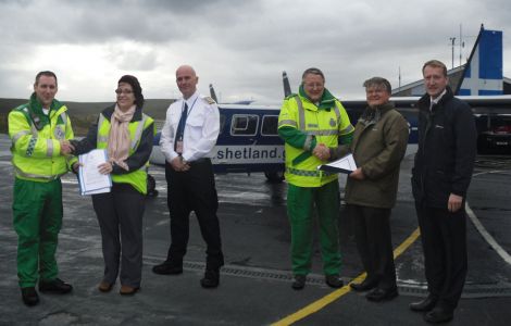 Shaking hands at Tingwall airstrip are (from left to right): Steve Munro, Air Area Service Manager, SAS; Julie Simpler, Director of Commercial, Directflight; Marshall Wishaw, Captain, Directflight; Peter Smith, Team Leader, SAS; Roger Diggle, Medical Director, NHS Shetland and Shetland MSP Tavish Scott - Photo: SAS
