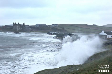 Waves crash in causing flooding and extensive damage at Leebitton, Sandwick, on Saturday. Pic. Garry Sandison
