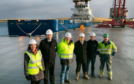 Left to right – Sandra Laurenson, Chief Executive, Lerwick Port Authority; Captain Calum Grains, Harbourmaster, Lerwick Port Authority; George Smith, Director, Tulloch Developments Limited; Andy Sandison, Partner Arch Henderson LLP; Alistair Tulloch and Frank Tulloch, Directors, Tulloch Developments Limited, at the new quay, with the standby vessel Sea Trout in the background - Photo: LPA