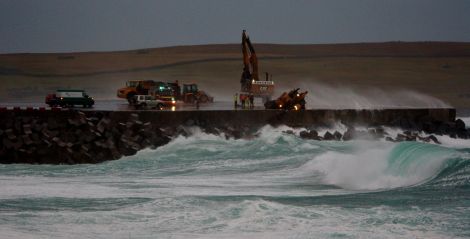 The scene at Sumburgh airport on Sunday morning as emergency services rescue the trapped digger driver. Photo Ronnie Robertson