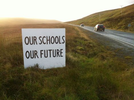 One of many signs that have sprung up across the isles in protest at the council's school closure plans.
