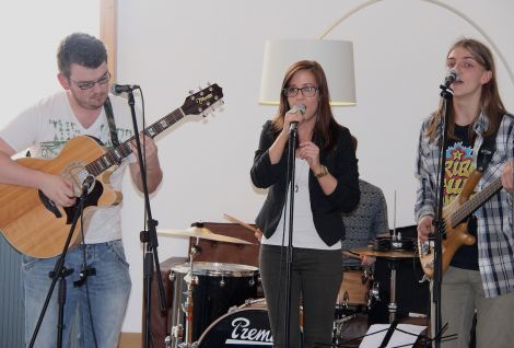 Bressay teacher Lisa Johnson sings 'Denied' at the launch of her EP upstairs at Mareel, backed by the song's writer Joe Watt (right) and Matthew Adam, with drummer Lewis Murray hiding in the background. Photo Davie Gardner