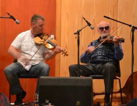 Maurice Henderson enjoys a tune with sprightly 83-year-old Fetlar stalwart Joe Jamieson. Photo: Shetnews
