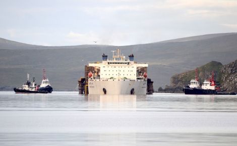Four tugs - three from Orkney - keep a close watch as the Xiang Yun Kou unloads. Photo: Mark Berry