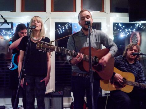 Yorkshire-bred singer songwriter Adam Guest, flanked by Louise Thomason and Arthur Nicholson, during his EP launch at Lerwick Boating Club. In the background is fiddle player Catherine Brown. Photo: Chris Brown