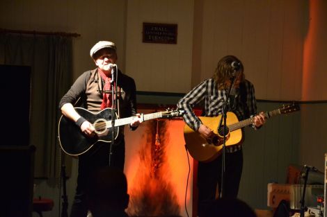 Dean Owens on stage at Muckle Roe Hall last night, with Arthur Nicholson - and a curious-looking fireplace - in the background.