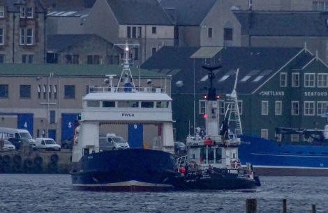 The harbour tug Knab is taken Fivla back to Lerwick - Photos: John Bateson