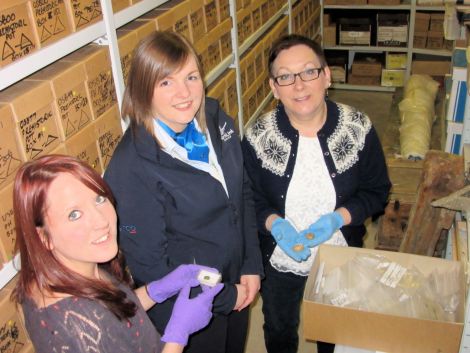 Collections curator Jenny Murray (right) and her assistant Laurie Goodlad (left) show NorthLink's Cheryl Kelday the artefacts. Photo Shetland Amenity Trust