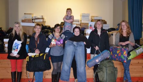 Volunteers helping the Shetland Solidarity with Refugees effort at Hamnavoe Hall on Wednesday evening. From left to right: Kaila McCulloch, Hazel MacIntyre, Zuzanna O'Rourke, six year old Lois Arthur (above), Wendy Sinclair, Emma Harmer and Rona Arthur. Photo: Shetnews/Neil Riddell