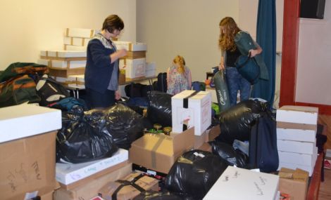 Volunteers sifting through bags and boxes bound for the Calais refugee camp.