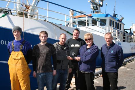Ian Shearer (centre) receiving his award from Caroline Hepburn of the NAFC Marine Centre. Also in the photo are (from left) Christopher Irvine, Malcolm Reid, Davie Shearer and Leslie Tait. Photo: NAFC