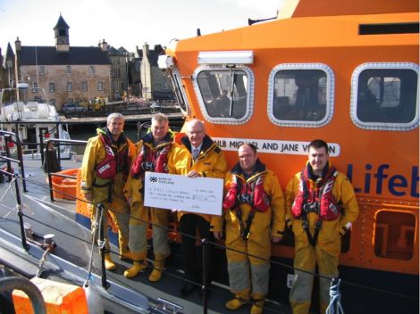 The lifeboat team gratefully receiving Bertie Tait's cheque.
