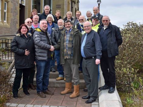 The SNP's Shetland branch convener Iain Malcolmson welcoming retiring SIC councillor Jonathan Wills into the fold outside Islesburgh on Saturday.