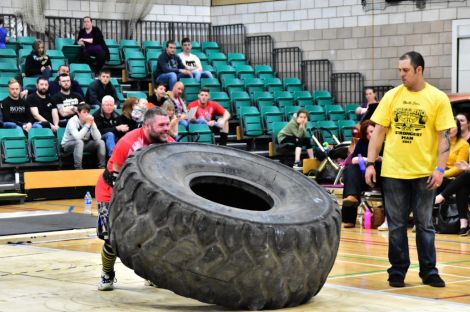 Shetland's new strongest man Jonni Manson in action during the tyre flip event. Photo: Mark Berry