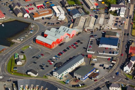 The shopping centre and its car park seen in the middle of the photo.