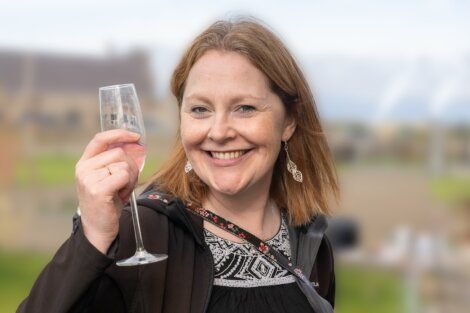 A woman holding a wine glass.