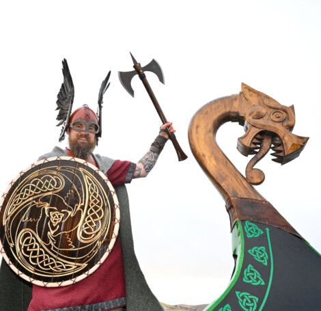 A man wearing a viking helmet.