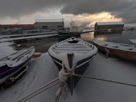 A boat docked in the snow.